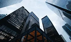 A skyline view featuring tall buildings against a clear blue sky in an urban setting.